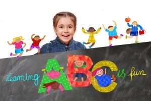 Child holding a sign saying learning ABC is fun.