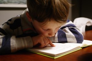 young boy reading a book